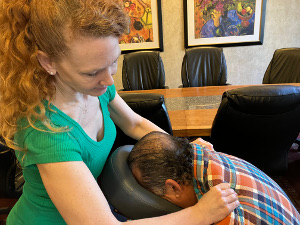 Closeup of corporate chair massage on traps in Minneapolis